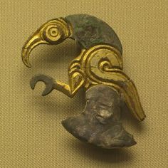 an old bronze mask with a bird's head on it