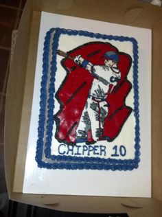 a cake in the shape of a baseball player with a bat on it's shoulder