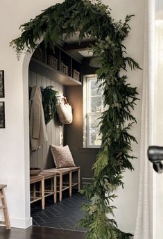 the entry way is decorated with greenery