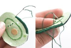 someone is stitching something with green thread