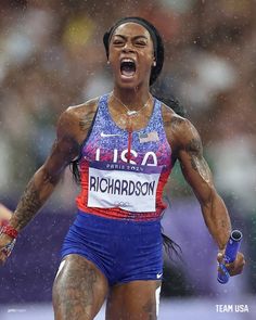 a woman with her mouth open and holding an object in one hand while running through the rain