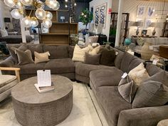 a living room filled with lots of couches and pillows on top of a floor