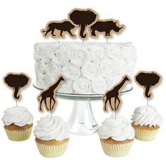 some cupcakes are sitting on top of a cake with giraffe decorations