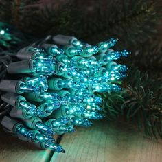 a bunch of christmas lights sitting on top of a wooden table