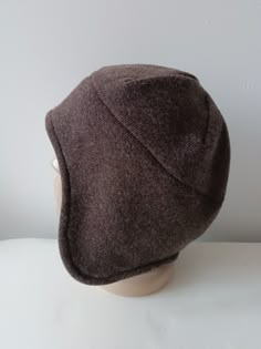 Italian wool hat/ boiled wool Jersey. Unisex Earflap winter hat Hight quality knitted wool jersey fabric with soft felted face side.Double sided wool fabric. Earsflap part double layered. Warm winter hat Brown face side/ soft Grey inside Hat Size: S / inch 21 1/4 - 21 5/8 * metric  54-55cm M/ inch 22-22 3/8 * metric 56-57 cm  L/ inch 22 3/4 - 23 1/8 * metric 58-59 cm XL/inch 23 1/2 - 24 * metric 60-61cm 2X/ inch 24.4 - 24 5/8 * metric 62-63 cm Wool 68% poliester 23 % acril 9% Gentle machine or hand washable. Handmade to the order Shipping by Priority Air Mail or use shipping upgrades for Fedex shipping Men’s Winter Hat, Cool Hats For Men, Cute Winter Hats, Hoodie Hat, Felted Hat, Earflap Hat, Mens Hats, Mens Hat, Winter Hats For Men