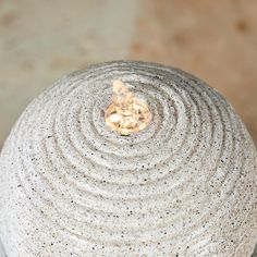 a white vase sitting on top of a table