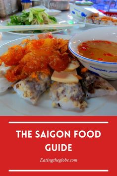 the saigon food guide is shown on a plate with soup and vegetables in bowls behind it