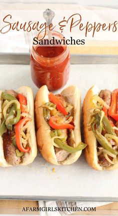 sausage and peppers sandwiches with ketchup on the side