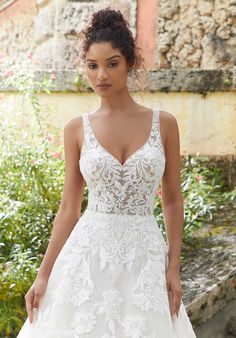 a woman in a wedding dress standing outside