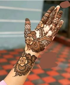 a woman's hand with henna on it