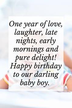 a baby laying on top of a bed next to a sign that says, one year of love, laughter late nights early mornings and pure delight happy birthday to our