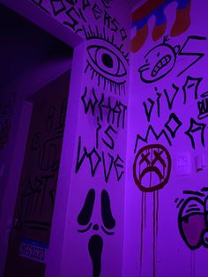 some graffiti on the side of a building with purple light in front of it and an evil eye painted on the wall