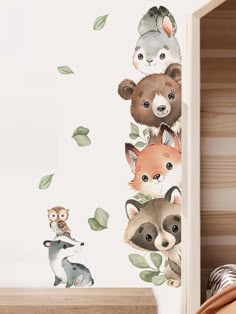 an animal themed wall sticker in a child's room with leaves and animals on it