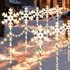 lighted snowflakes and candy canes in the snow