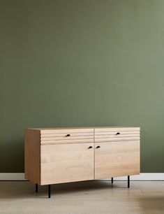 the sideboard is made from wood and has two drawers on each side, with black legs