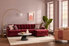 a living room filled with furniture and pink walls