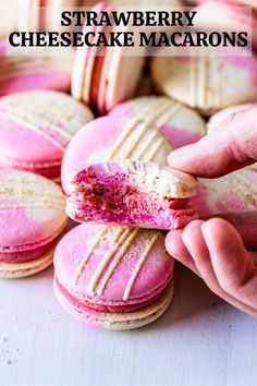 a person is holding a pink and white macarons in front of them with the words strawberry cheesecake macaroons