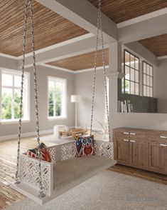 a living room filled with lots of furniture and hanging decorations on the ceiling above it