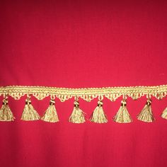 gold tasselled trim on a red background