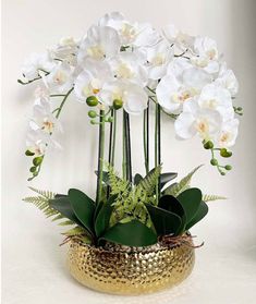 This orchid arrangement is planted in a stunning Gold ceramic planter. The modern vase makes it look great anywhere in your home! Product detail: Material: PEVA Real Touch Size: 21.6 Inches Tall Color: Green Gold Ceramic pot Handmade Care: The flower can be washed with water. Imported Orchid Vase, Orchid Flower Arrangements, Diy Outdoor Fireplace, Artificial Orchids, Orchid Arrangements, Arrangement Ideas, Phalaenopsis Orchid, Vase Arrangements, Metal Vase