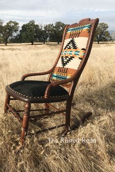 an old rocking chair in the middle of a field