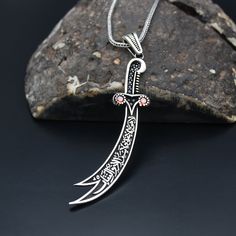 "Zulfiqar Necklace, 925 Sterling Silver Necklace, Sword Design, Handmade Necklace, Gift for Him, Ali Zulfiqar Sword Necklace ✦ Details ✦ * Material: 925 Sterling Silver * Weight of pendant : 8,50  gram *  Chain Weight :     20 Inches = 5.00 Gr     22 Inches = 5.60 Gr     24 Inches = 6.05 Gr     26 Inches = 6.10 Gr     28 Inches = 6,40 Gr * Sides oxidized * Stamp: 925 ✦ Shipping ✦ * Processing time: 1-3 business days. * This item ships from my Turkish workshop in Istanbul. * Add your phone number in address box for a smoother delivery. That makes courier personnel's job easier.  ✦ Packaging ✦ * Comes with a luxury gift box and a jewellery cleaning cloth and courtesy gift. ✦ Returns, Exchanges ✦ * Return option available for 30 days after the delivery. * The product has to be in the same sha Zulfiqar Necklace, Men Jewelry, Silver Work, Luxury Gift Box, Handmade Necklace, Necklace Gift, Sterling Silver Necklace, Handmade Necklaces, Sterling Silver Necklaces