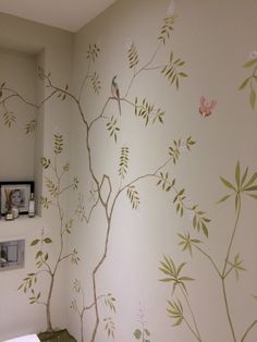 a bathroom with a tree painted on the wall