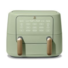 a green toaster sitting on top of a white counter next to two brown handles