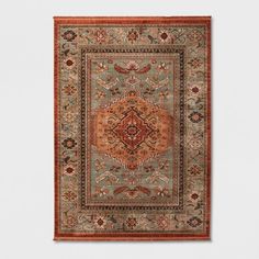 an orange and blue area rug on a white wall with a red border around it