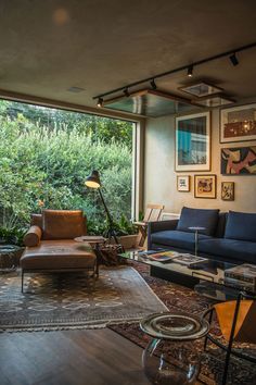 a living room filled with furniture and lots of windows