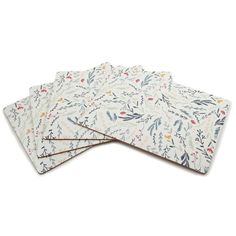 four place mats with floral designs on them