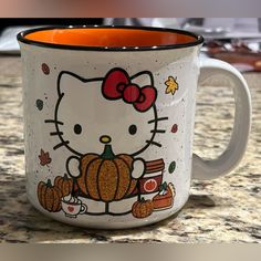 a hello kitty coffee mug sitting on top of a counter