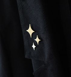 a black jacket with gold stars on it