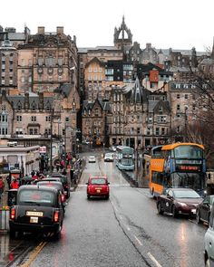 cars and buses on a city street in the rain