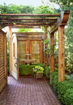 an open door leading into a lush green garden