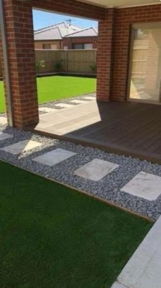 an outdoor patio with stepping stones and grass