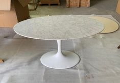 two tables sitting on top of a table covered in plastic