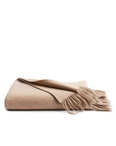 a tan blanket with fringes on it