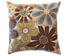 a brown and blue pillow with flowers on it