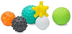 three different colored balls and one is black, white, yellow, green, orange