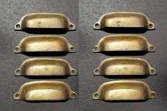 four old brass door handles are shown in three different angles, one is slightly open and the other half closed