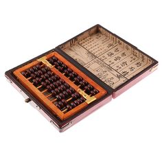 an open wooden box filled with lots of brown and black chess pieces on top of each other