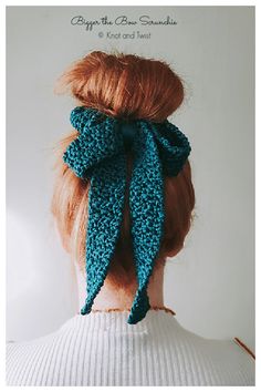 a woman with red hair wearing a blue crochet bow in her back view