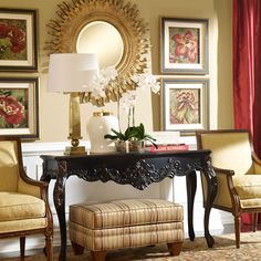 a living room filled with furniture and pictures on the wall above it's coffee table