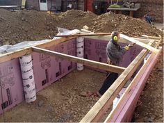 a man standing in the middle of a building under construction