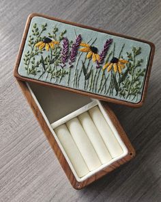 an open box with some candles in it