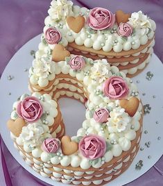 the cake is decorated with flowers and hearts