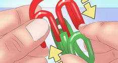 two hands holding red and green scissors with arrows pointing to the right, while another person holds them in their left hand