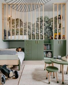 a child's bedroom with green furniture and decor on the walls, along with a bed