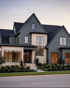 a large gray house with lots of windows